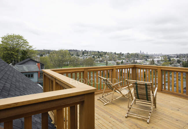 Wooden house balcony looking out over urban area. — Stock Photo