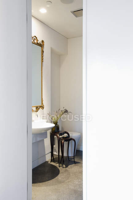 Powder room with toilet and hand basin and mirror. — Stock Photo