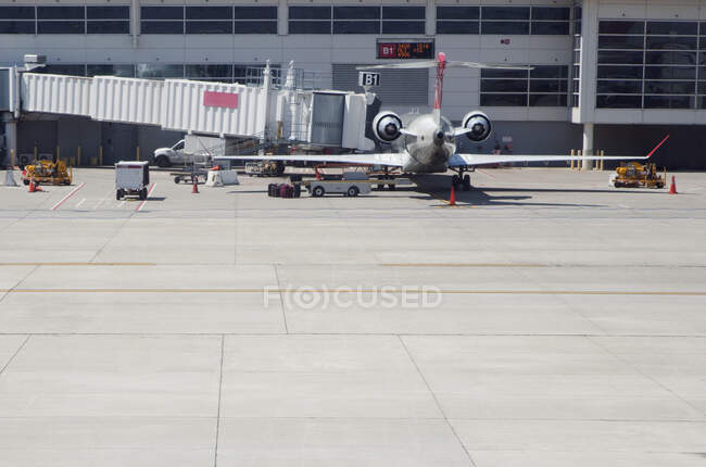Airplane with air bridge at airport. — Stock Photo