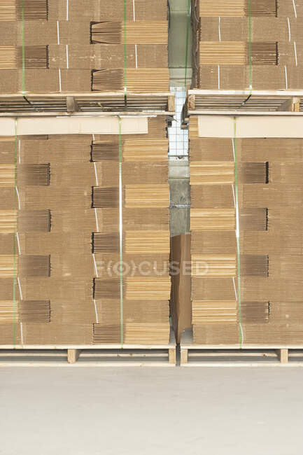 Pallets of flat folded cardboard boxes. — Stock Photo