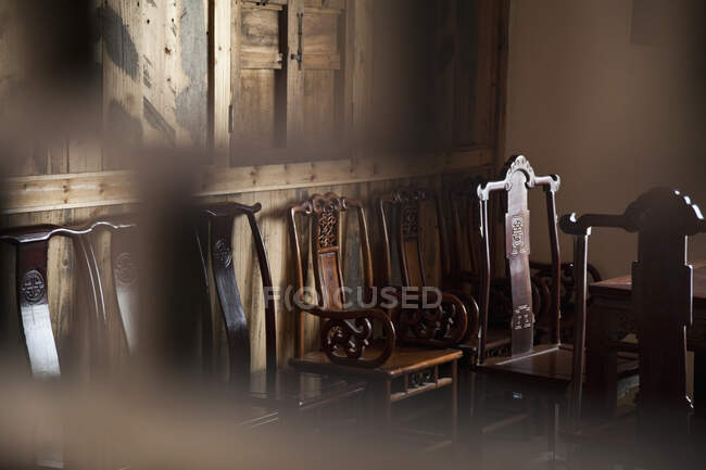 Dining chairs in wooden panelled room — Stock Photo