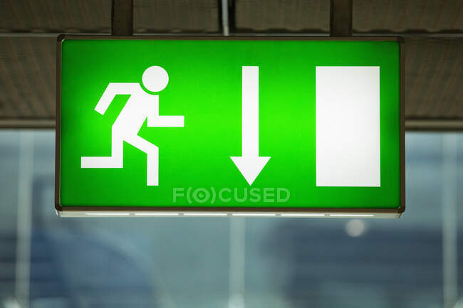 Lit emergency exit sign. — Stock Photo
