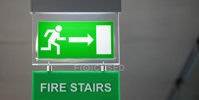Lit emergency exit sign. — Stock Photo