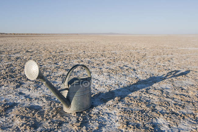 Watering can on salt flat or sand. — Stock Photo
