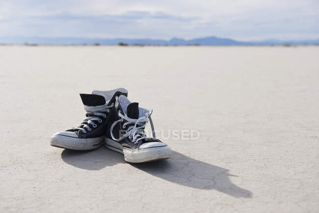 Sneakers on salt flat, close-up view — Stock Photo