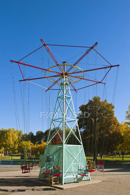 Merry go round in a park with suspended seating. — Stock Photo