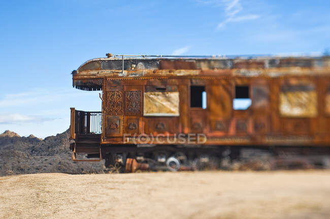 Rusty vintage train carriage in desert. — Stock Photo