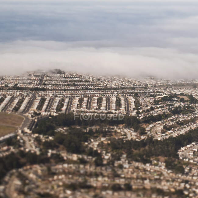 Suburbs with cloud cover, aerial view — Stock Photo