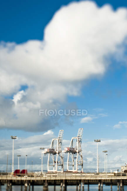 Cranes lined up on the wharf, dockside lifting equipment — Stock Photo