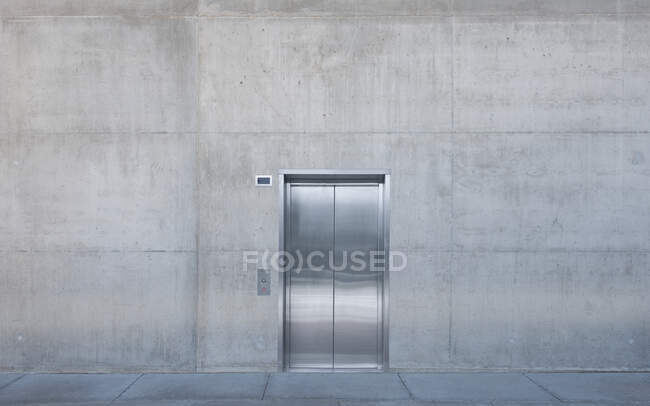 Metal elevator doors in a concrete wall. — Stock Photo