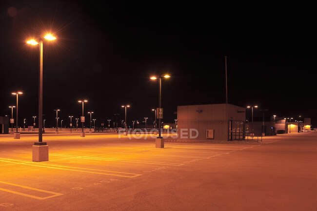 Empty parking lot with street lights at night. — Stock Photo