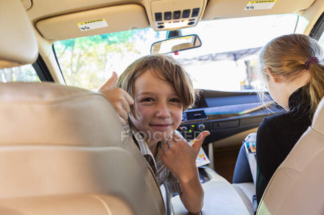Young boy looking at camera in parked car. — Stock Photo