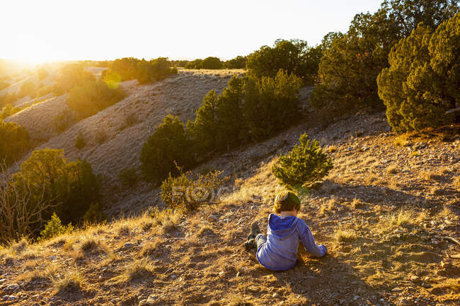 Young boy in Galisteo Basin at sunset, Santa Fe, NM — Stock Photo