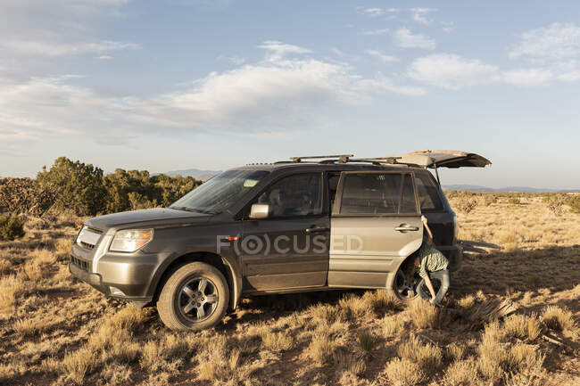 Young boy beside an SUV, Galisteo Basin, Santa Fe, NM. — Stock Photo