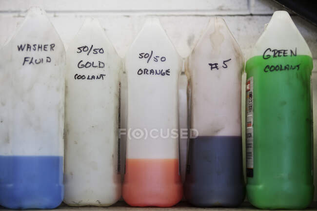 Fluids used in auto repair shop stand all in a row — Stock Photo