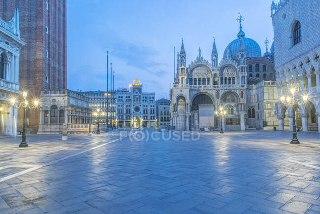Dawn, Saint Mark's Square, Basilica San Marco, Piazza San Marco, historic buildings, and street lamps. — Stock Photo