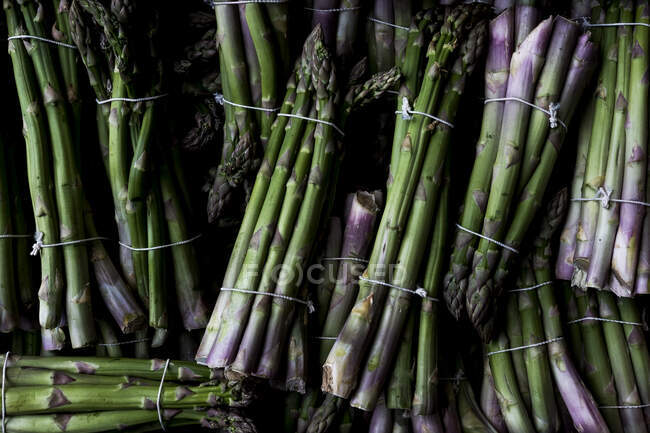 High angle close up of freshly picked bunches of green asparagus. — Stock Photo