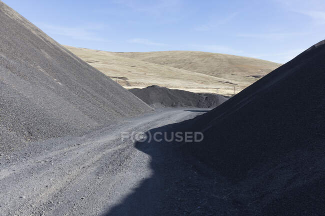 Gravel pile used for road construction and maintenance — Photo de stock