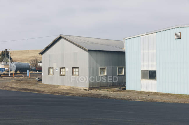 Agricultural storage buildings by a road — Stock Photo