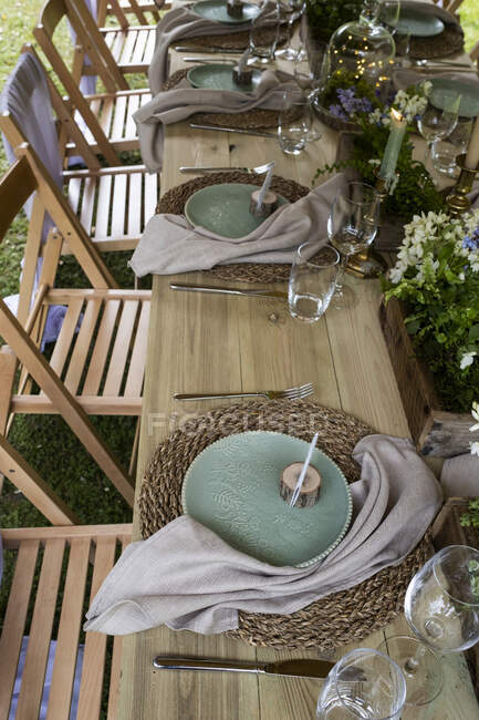 High angle close up of rustic place settings for a woodland naming ceremony. — Stock Photo