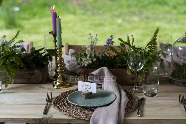 High angle view of rustic place setting for a woodland naming ceremony. — Stock Photo