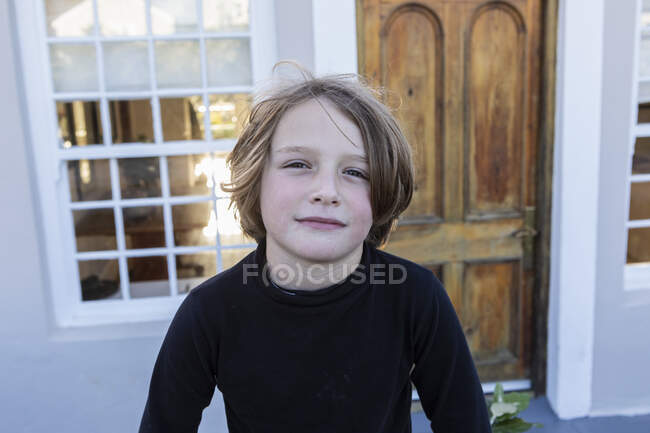 Young boy outside his home, portrait — Stock Photo