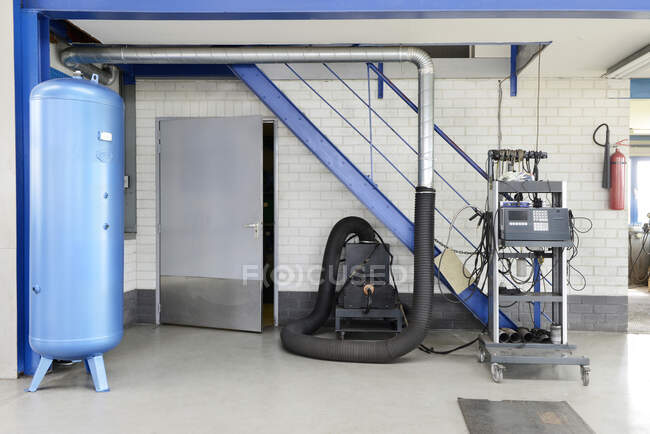 A garage or auto repair shop air pressure valve with compressor machine — Stock Photo