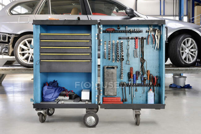 Utensili su un carrello organizzato in file in un'officina di riparazione auto. — Foto stock