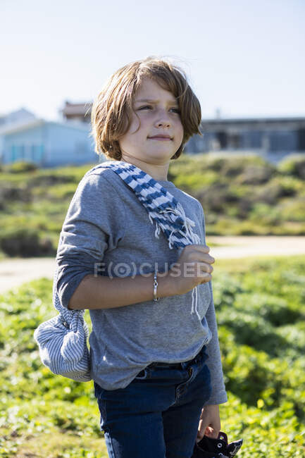 Portrait of a young boy outdoors dressed as a pirate with a hat and striped scarf. — Stock Photo