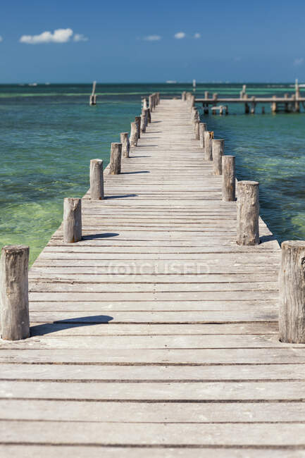 A long wooden jetty or pier,stretching out over the water — Stock Photo