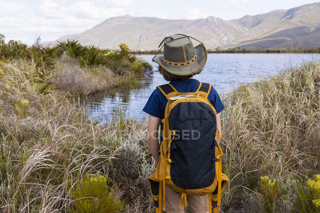 Young boy looking at pond, Stanford Valley Guest Farm, Stanford, Western Cape, South Africa. — Stockfoto