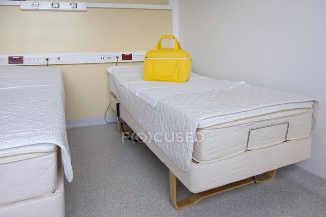 Две кровати в родильном отделении, ярко-желтая сумка. — стоковое фото