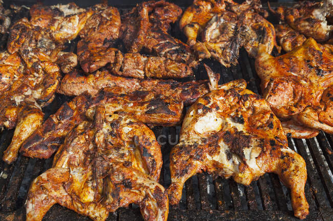 Chickens cooking on a barbeque grill — Foto stock
