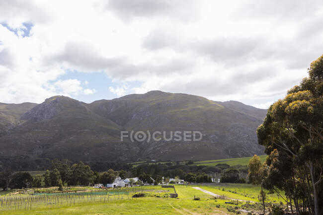 Elevated view over landscape and farmland under the shadow of a mountain range — Stock Photo