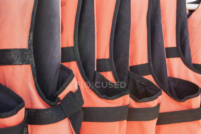 Close-up of orange life jackets in a row — Foto stock