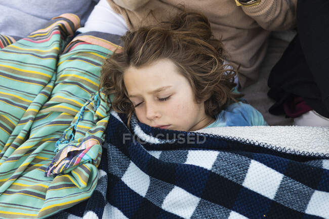 Young boy resting under blanket, De Kelders, Western Cape, South Africa. — Foto stock