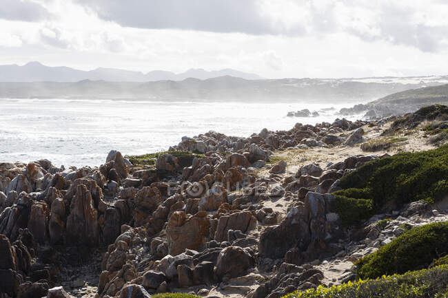 La costa rocosa del océano Atlántico, olas y nubes - foto de stock