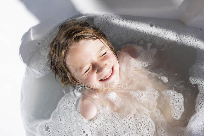 Восьмирічний хлопчик у ванні, купаючись. — стокове фото