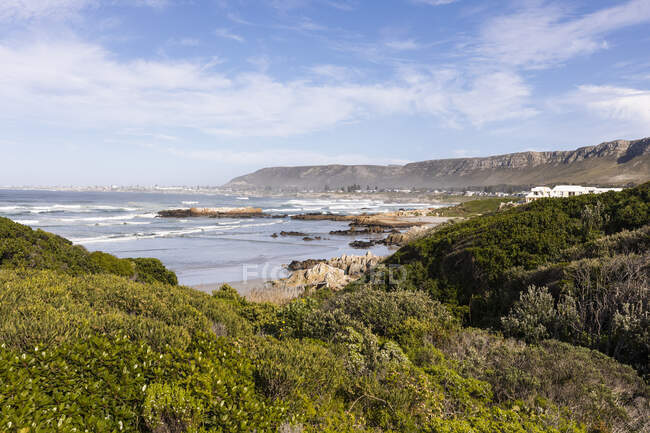 Praia arenosa e formações rochosas, vista elevada, ondas quebrando na costa. — Fotografia de Stock