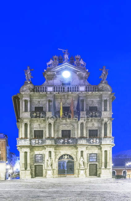 Pamplona City Hall lit up at dusk. — Stock Photo