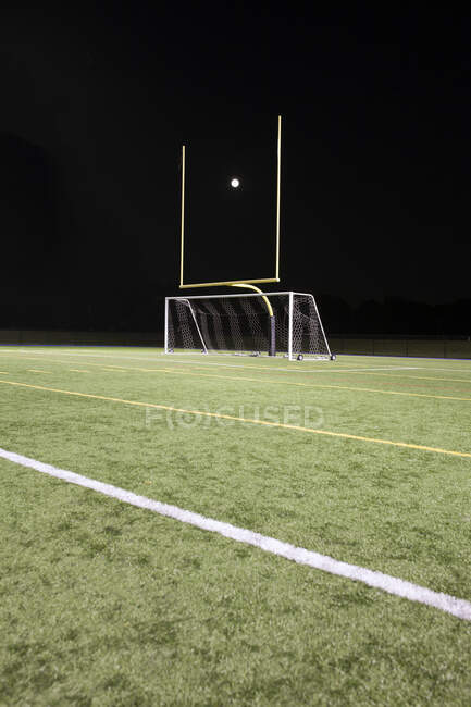 Белый мяч между столбами на спортивной площадке, забивая — стоковое фото