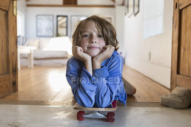 Portrait de garçon de 8 ans avec planche à roulettes — Photo de stock