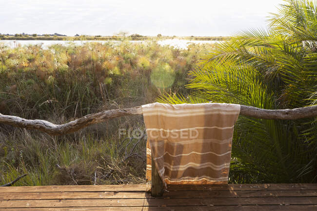 Towel over a rail at a safari camp, sunrise over the wetlands of the Okavango delta — Stock Photo
