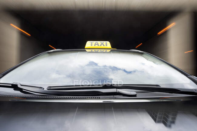 Taxi cab emerging from a garage. - foto de stock