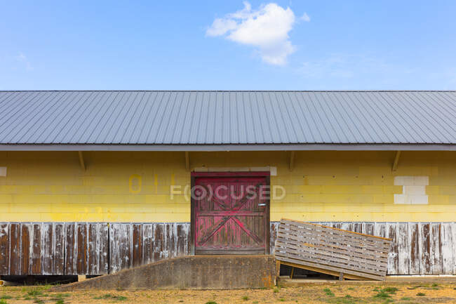 Old loading dock and warehouse, deserted building, exterior, blocked doors. — Stock Photo