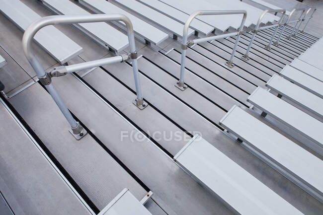 Bleachers, looking down the steep steps and raked seating of a stadium. — Fotografia de Stock