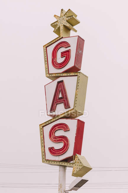 A retro style GAS station sign, red lettering road sign. — Stock Photo