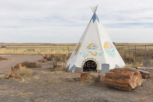 Teepee and wood logs at abandoned roadside rest stop. — Stock Photo