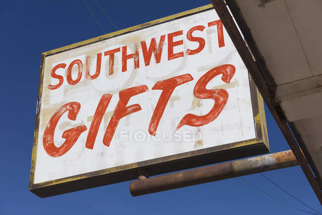 Sign advertising Southwest Gifts on a deserted main street. — Stock Photo