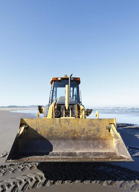 Bulldozer on a sandy beach. — Stock Photo